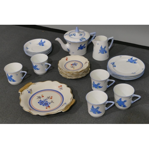 109 - A Weimar scallop shaped plate with 6 matching smaller plates on white ground with red and blue flora... 