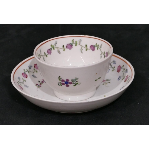 119 - A early 19th Century Newhall tea bowl and saucer on white ground with puce, blue and green floral le... 