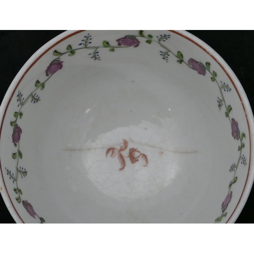 119 - A early 19th Century Newhall tea bowl and saucer on white ground with puce, blue and green floral le... 