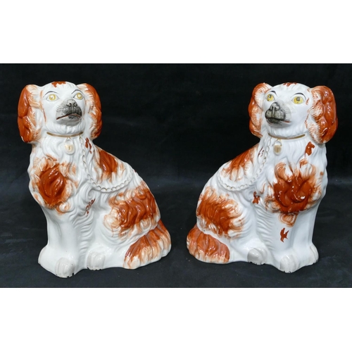 126 - A pair of 19th Century Staffordshire figures of seated spaniels on white and red ground, painted eye... 