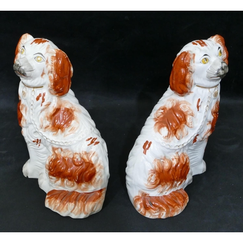 126 - A pair of 19th Century Staffordshire figures of seated spaniels on white and red ground, painted eye... 