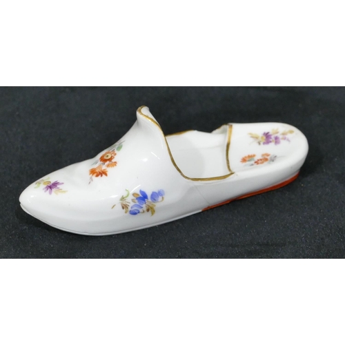 134 - A Meissen porcelain miniature slipper with allover multi-coloured floral, leaf and gilt decoration, ... 