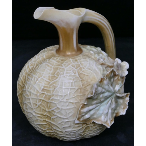 138 - A Royal Worcester blush round bulbous thin necked jug with branch shaped handle, raised leaf decorat... 