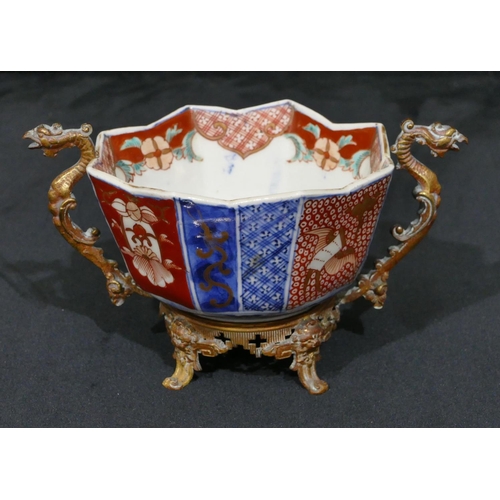 143 - A 19th Century Oriental Imari pattern octagonal shaped bowl with crinkled rim, mounted in gilt metal... 