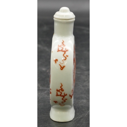 15 - An Oriental china balloon flask shaped snuff bottle with stopper on white ground with red dragon dec... 