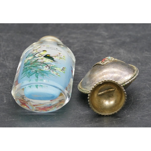 16 - An oval glass Oriental snuff bottle with stopper with inner painted bird, branch and floral decorati... 