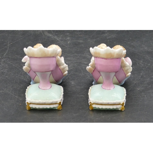 19 - A pair of 19th Century Meissen style groups of cupids seated in old shoe, 8.2cm high