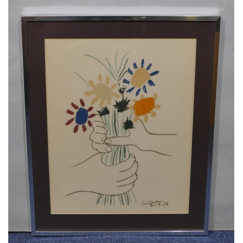 195 - A modern coloured print after Picasso depicting hands clasping a bunch of flowers, in silvered frame... 