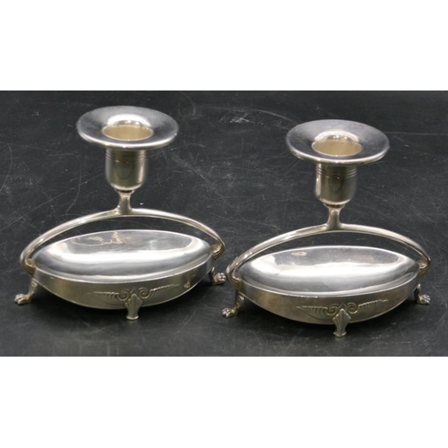 211 - A pair of WMF dwarf candlesticks on oval bases with splayed claw feet, 9.5cm high