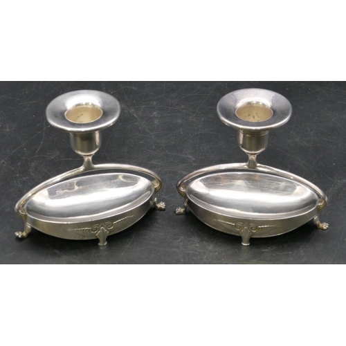 211 - A pair of WMF dwarf candlesticks on oval bases with splayed claw feet, 9.5cm high