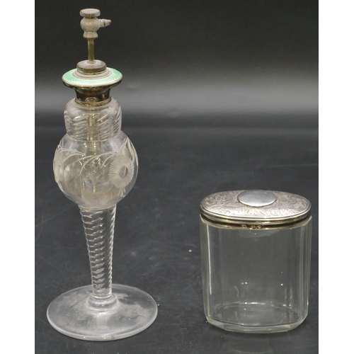 218 - A cut glass round bulbous shaped spray scent bottle, silver top with green enamelled decoration, 20.... 