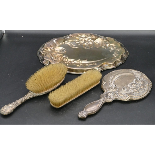 224 - A Birmingham silver hand mirror with embossed floral and scroll decoration (pin holes allover), a Bi... 