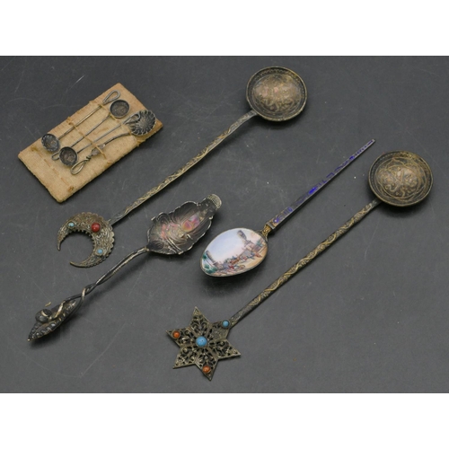 226 - An 800 silver coloured metal enamelled teaspoon with bowl depicting figures on camels in market plac... 