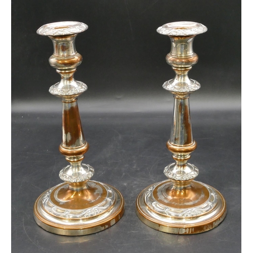 233 - A pair of 19th Century Sheffield plated candlesticks on turned stems with round sweeping bases, part... 