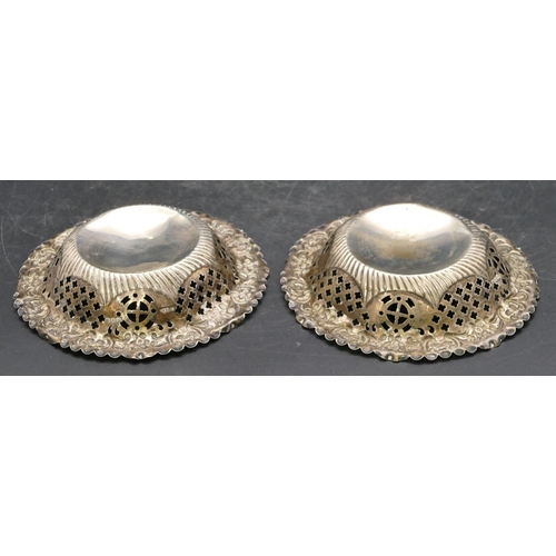 241 - A pair of Birmingham silver small round sweetmeat dishes with embossed and pierced rims, 12cm diamet... 