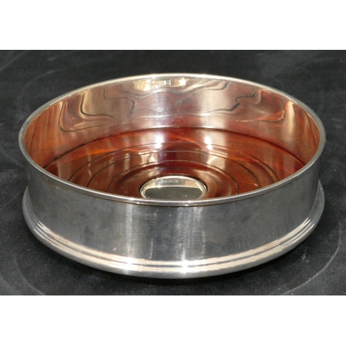 258 - A modern London silver wine coaster with wooden centre, 12.8 cm diameter.