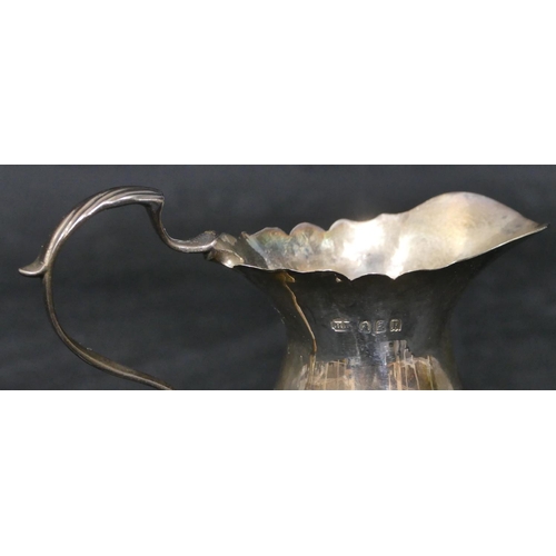 276 - A Britannia silver round bulbous shaped cream jug with crinkled rim, scroll handle and splayed hoof ... 