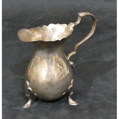 276 - A Britannia silver round bulbous shaped cream jug with crinkled rim, scroll handle and splayed hoof ... 