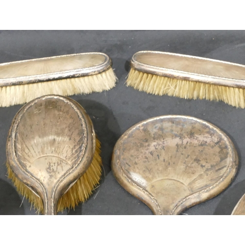 284 - A 4-piece Sheffield silver mounted dressing table set, hand mirror and 3 brushes, a pair of London s... 