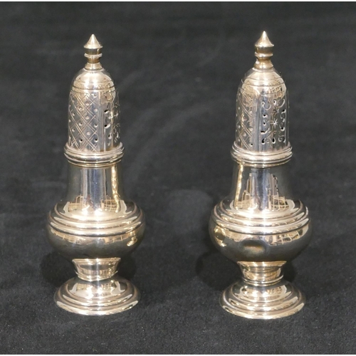 289 - A pair of Birmingham silver small round bulbous shaped pepperpots on sweeping bases, 9cm high 1.8oz