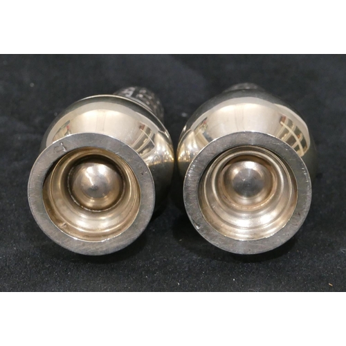 289 - A pair of Birmingham silver small round bulbous shaped pepperpots on sweeping bases, 9cm high 1.8oz