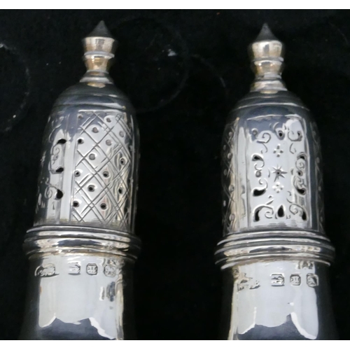 289 - A pair of Birmingham silver small round bulbous shaped pepperpots on sweeping bases, 9cm high 1.8oz