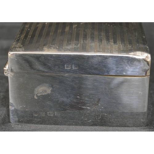 290 - A Birmingham silver rectangular shaped cigarette box with engine turned hinged lid, 16.2cm wide