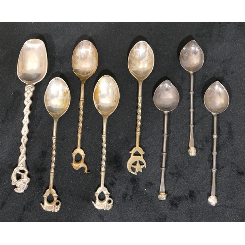 293 - A set of 4 Eastern silver coloured metal coffee spoons with elephant and camel finials, a set of 3 E... 