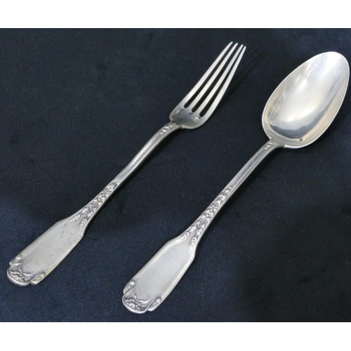 300 - A pair of Continental silver coloured metal christening spoon and fork with raised scroll and leaf d... 