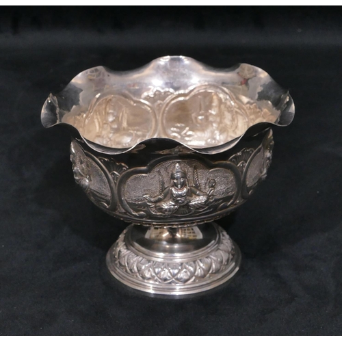 314 - An Eastern silver coloured metal round trumpet shaped sweetmeat dish with crinkle rim, embossed figu... 