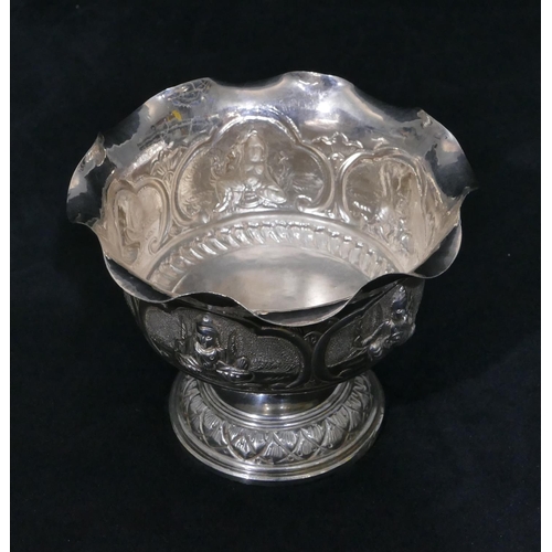 314 - An Eastern silver coloured metal round trumpet shaped sweetmeat dish with crinkle rim, embossed figu... 