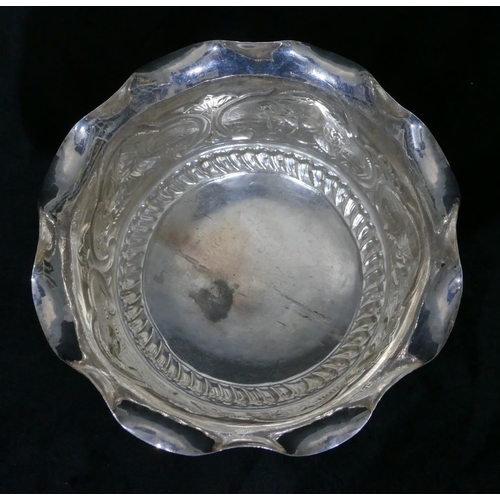 314 - An Eastern silver coloured metal round trumpet shaped sweetmeat dish with crinkle rim, embossed figu... 