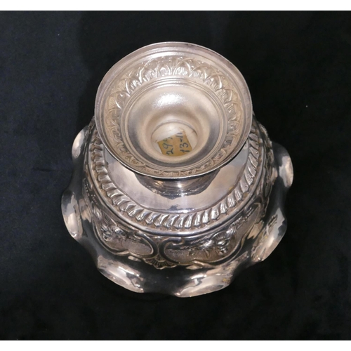 314 - An Eastern silver coloured metal round trumpet shaped sweetmeat dish with crinkle rim, embossed figu... 