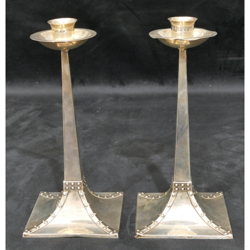 318 - A pair of James Dixon & Sons silver square candlesticks with tapering stems, splayed bases and studd... 