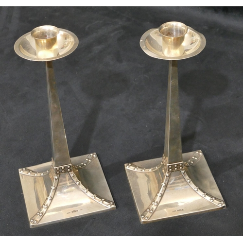 318 - A pair of James Dixon & Sons silver square candlesticks with tapering stems, splayed bases and studd... 