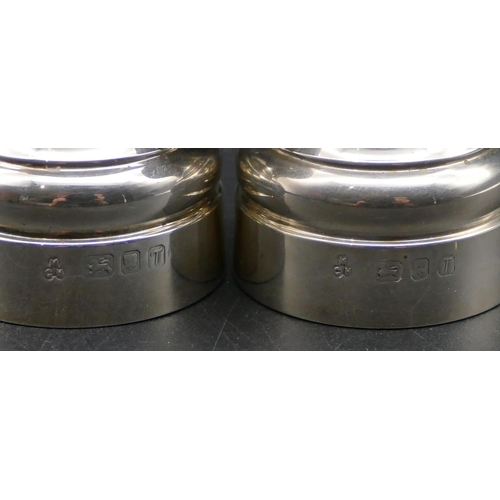 339 - A pair of modern London silver squat pepper and salt grinders, 7cm high.