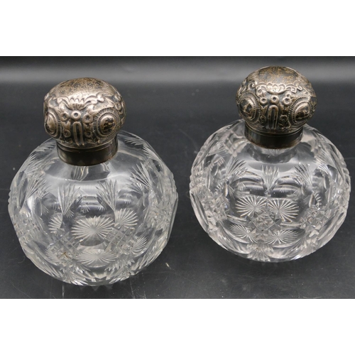 358 - A pair of George V heavy cut glass round bulbous shaped scent bottles with silver necks, hinged lids... 