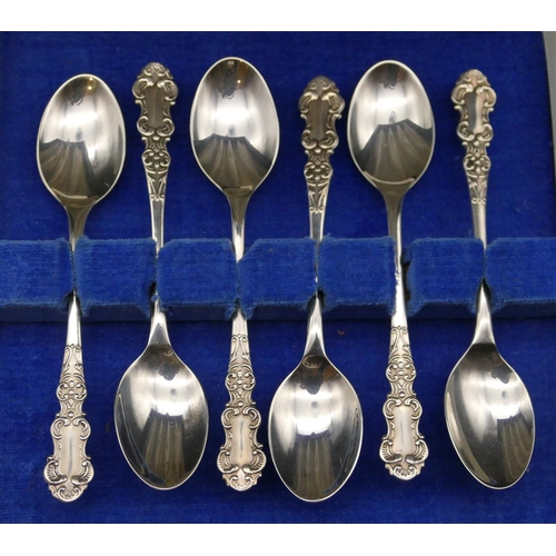 374 - A set of 6 modern Birmingham silver coffee spoons, scroll handles in fitted blue leather case, 1.4oz