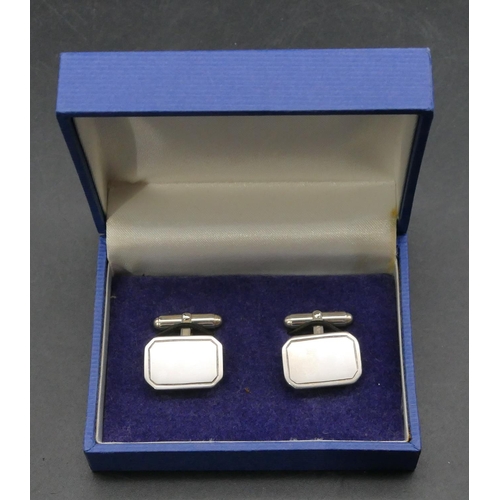 395 - A pair of modern silver plain rectangular shaped gentleman's cufflinks, boxed.