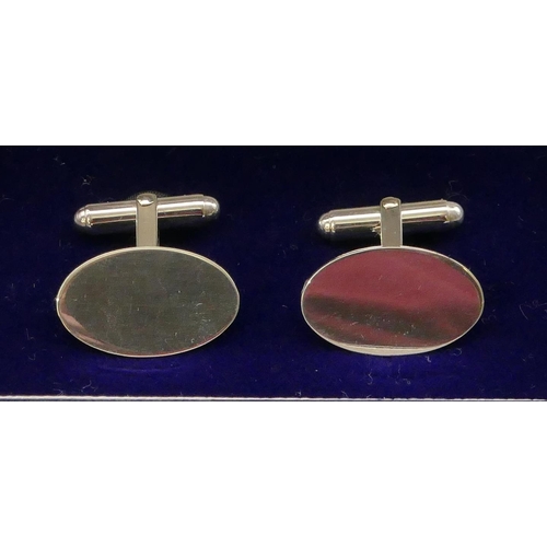 396 - A pair of modern silver oval plain gentleman's cufflinks, boxed.