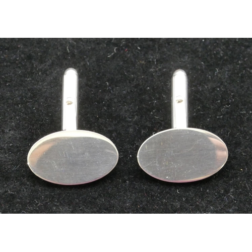 396 - A pair of modern silver oval plain gentleman's cufflinks, boxed.