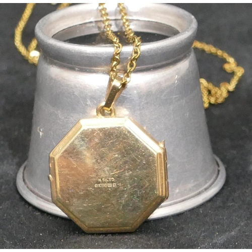 426 - A 9ct gold octagonal shaped locket with engraved leaf decoration, with chain, 5.1 grams