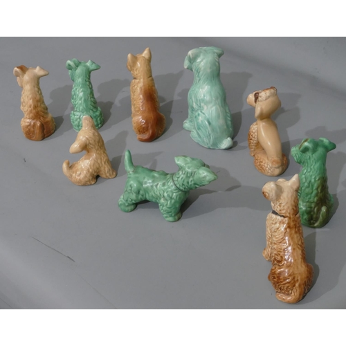 43 - 9 various Sylvac figures of seated dogs on beige and green ground, largest 16cm high