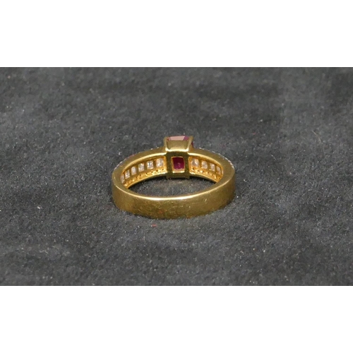 447 - An 18ct gold ladies ring set with centre ruby and flanked by various shaped diamonds, Size N, 5.9 gr... 