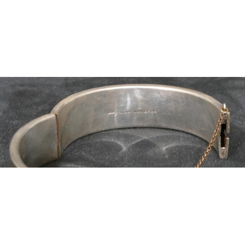 454 - A silver and gold covered hinged bangle, a small silver flat linked chain, a watch chain and a gentl... 