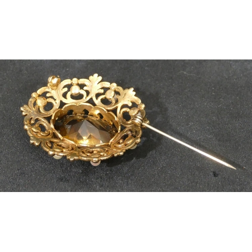 457 - A 9ct gold oval brooch with centre smoky quartz and surrounded by half pearls and pierced decoration... 