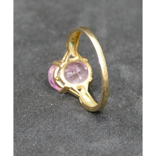 464 - A gold ladies ring set with oval purple stone, Size Y/Z, 4.6 grams