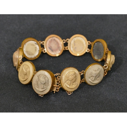 493 - A Lava oval panel bracelet with 10 oval panels with raised figurehead motifs