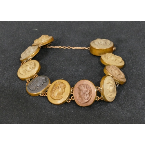 493 - A Lava oval panel bracelet with 10 oval panels with raised figurehead motifs