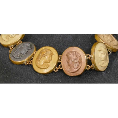 493 - A Lava oval panel bracelet with 10 oval panels with raised figurehead motifs